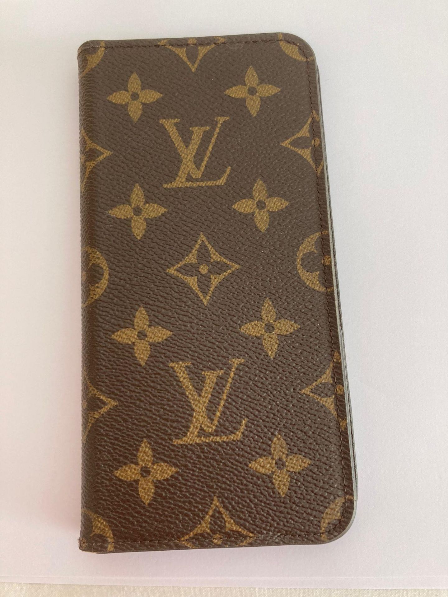 Genuine LOUIS VUITTON folio phone case for iPhone 7 or similar. Finished in brown leather with the
