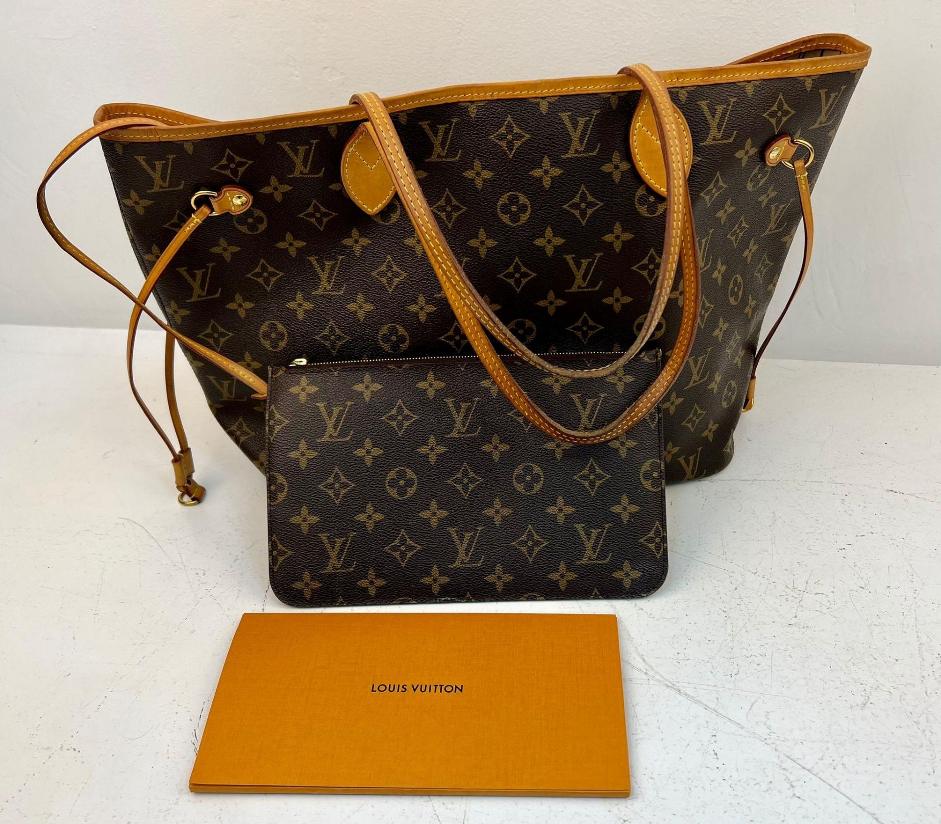 A Louis Vuitton Neverfull Tote Bag And LV Pouch! Brown monogram canvas exterior with leather handles