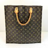 A Louis Vuitton Monogram Canvas Tote Bag. Brown leather handles. Spacious interior with two open