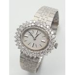 A STUNNING 18K WHITE GOLD OMEGA LADIES WATCH WITH TWIN ROW DIAMOND BEZEL ON OVAL SHAPED DIAL . 28