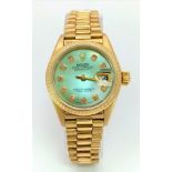 A LADIES 18K GOLD ROLEX WITH DIAMOND NUMERALS ON MOTHER OF PEARL DIAL .26mm