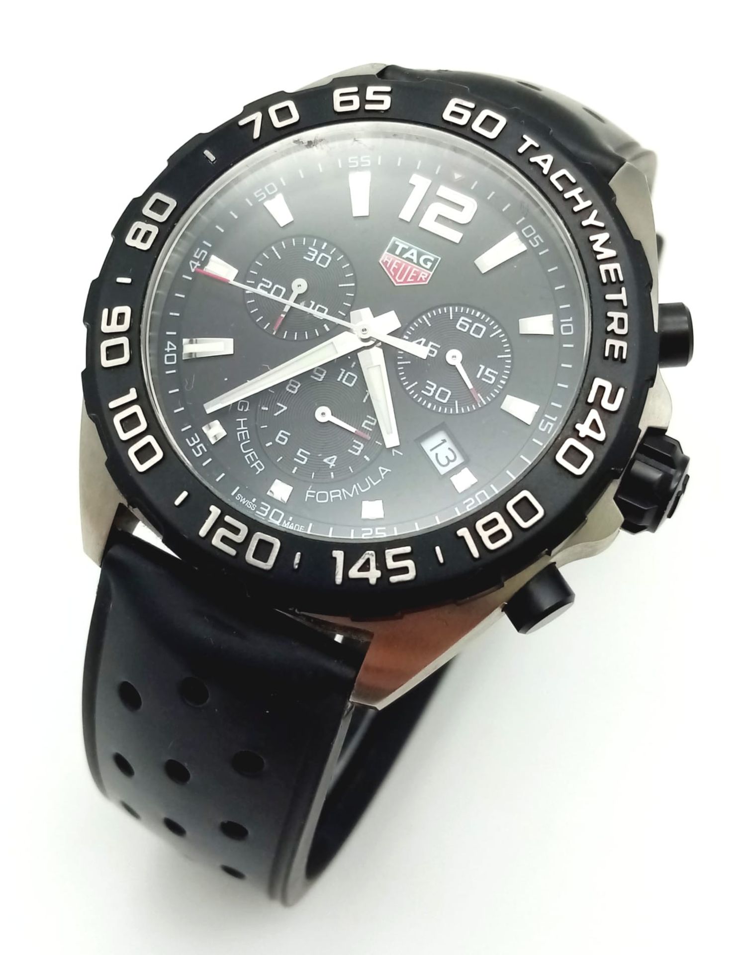 A Tag Heuer Formula Gents Chronograph Watch. Black rubber strap. Black dial with three sub dials.