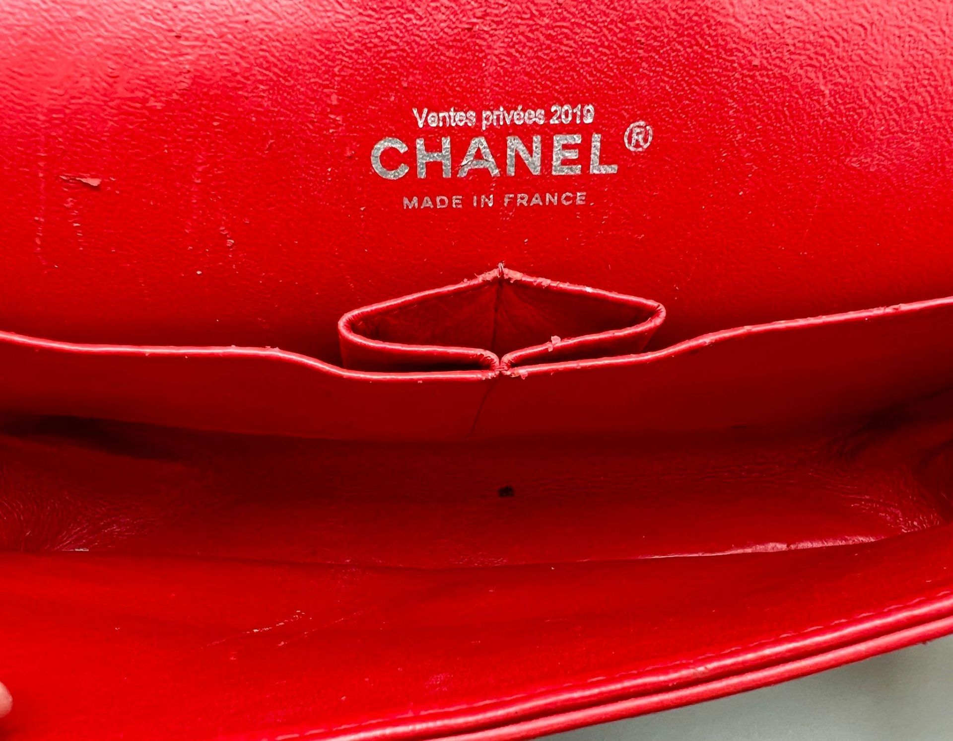 A Chanel Patent Leather Flap Handbag. Bright red patent leather quilted exterior. Classic Chanel - Image 6 of 7