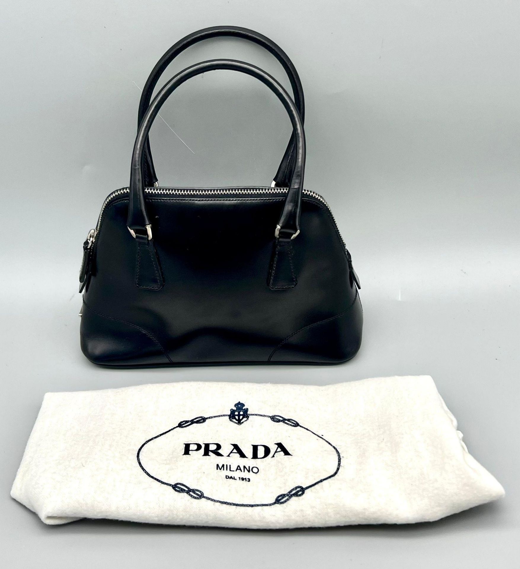A Prada Black Leather Mini Handbag. Classic shape with twin handles. Prada metal logo. Comes with - Bild 2 aus 7