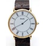 A Classic Vintage Ultra-Thin Piaget 18K Yellow Gold Watch. Brown leather strap. 18k gold case -
