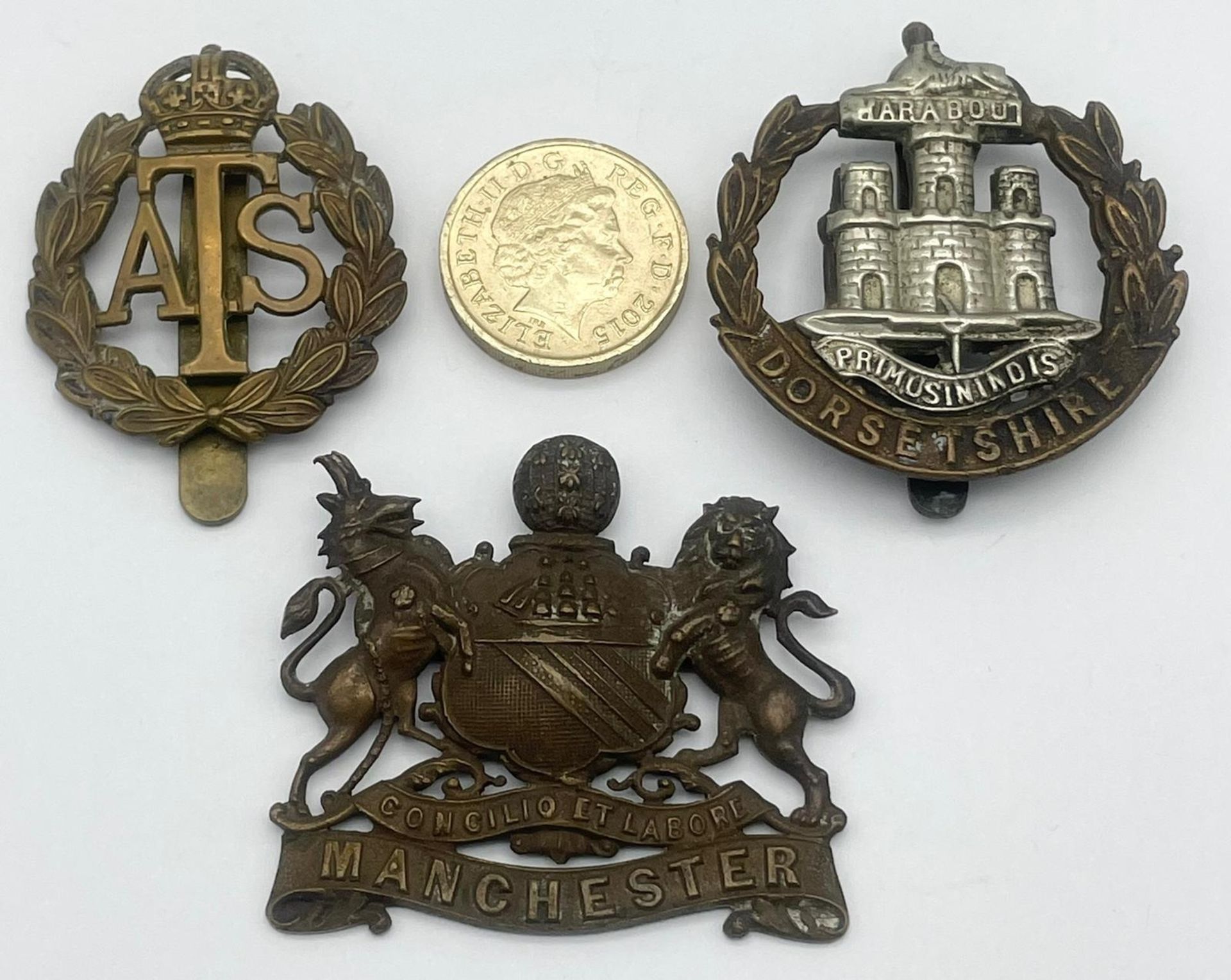 Three British Military Cap Badges: WW1 Dorsetshire Regiment Corp, WW2 Royal Artillery Manchester and - Image 2 of 6