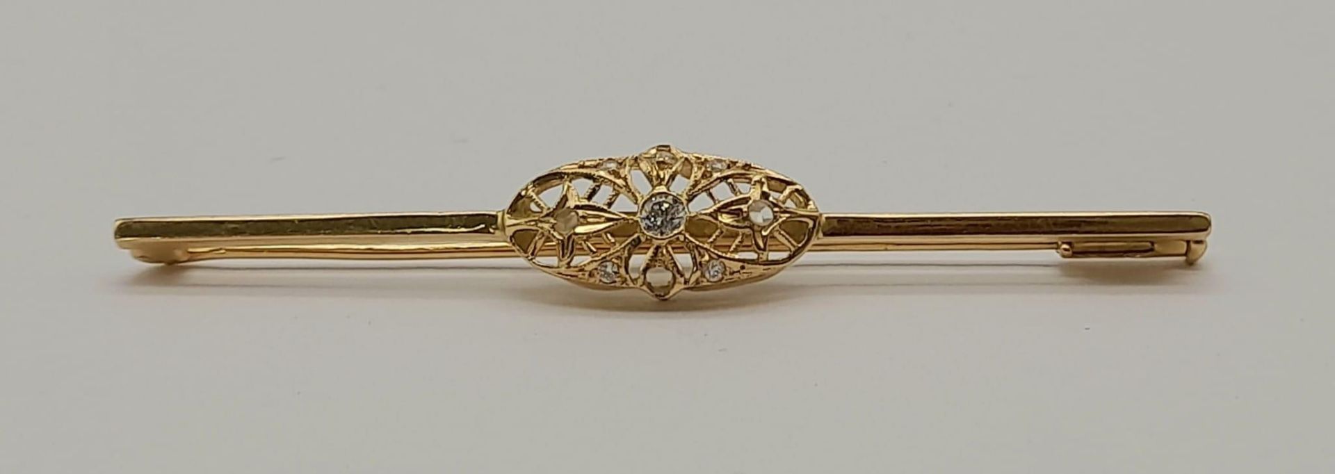 AN ANTIQUE 18K GOLD AND DIAMOND BAR BROOCH IN ART DECO STYLE . 4.7gms