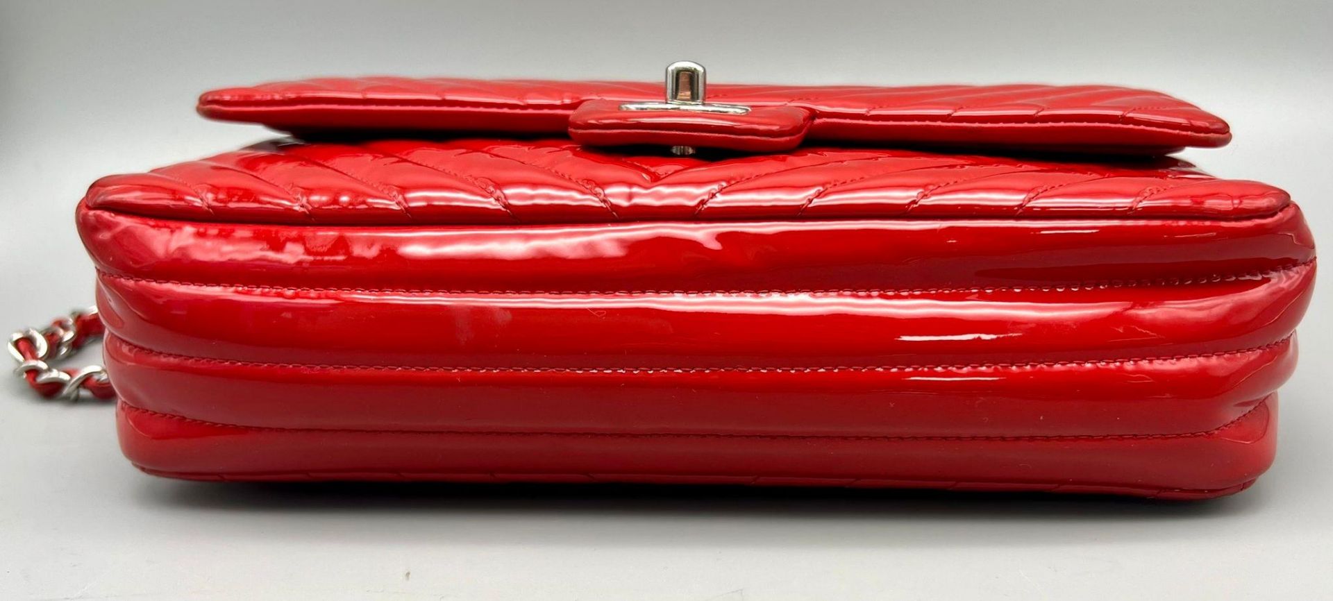 A Chanel Patent Leather Flap Handbag. Bright red patent leather quilted exterior. Classic Chanel - Image 4 of 7