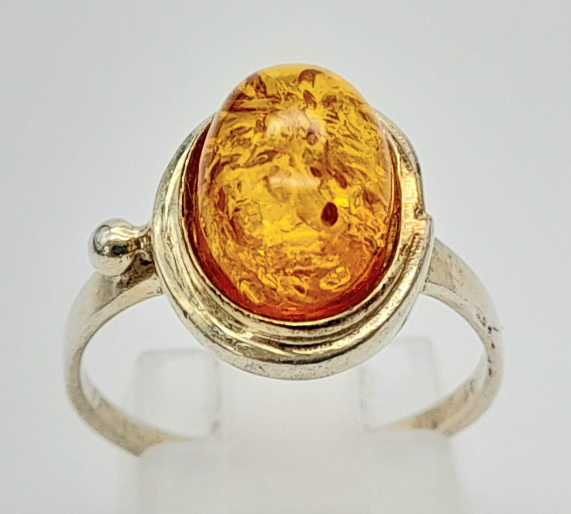 A Very Good Condition Modernist Design Sterling Silver Amber Cabochon Ring Size P. The Crown