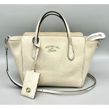 A Gucci Two-Way Ivory Leather Handbag. Handles and shoulder strap. Gilded hardware plus Gucci logo
