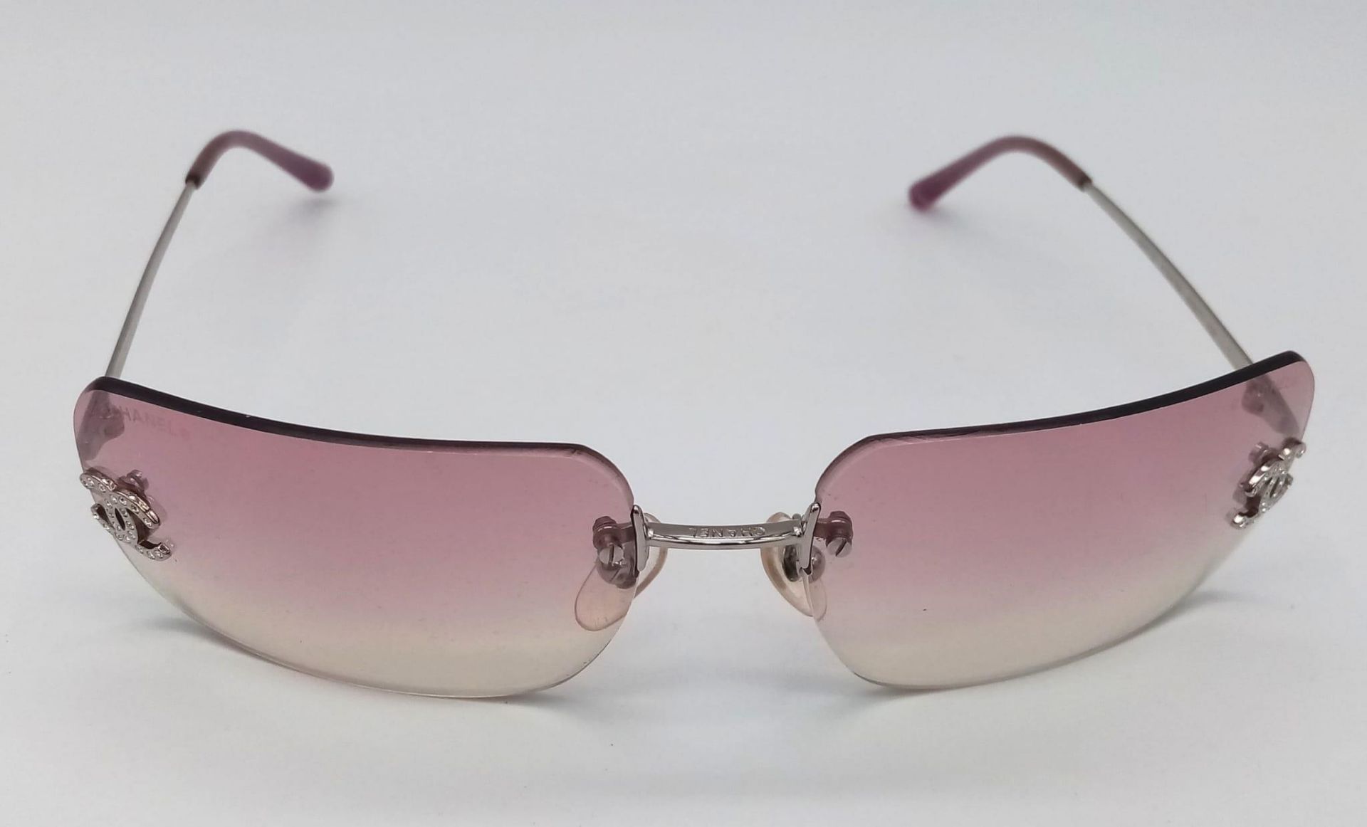 A Pair of Ladies Chanel Sunglasses with Chanel Case. Glasses in good condition - case is worn.