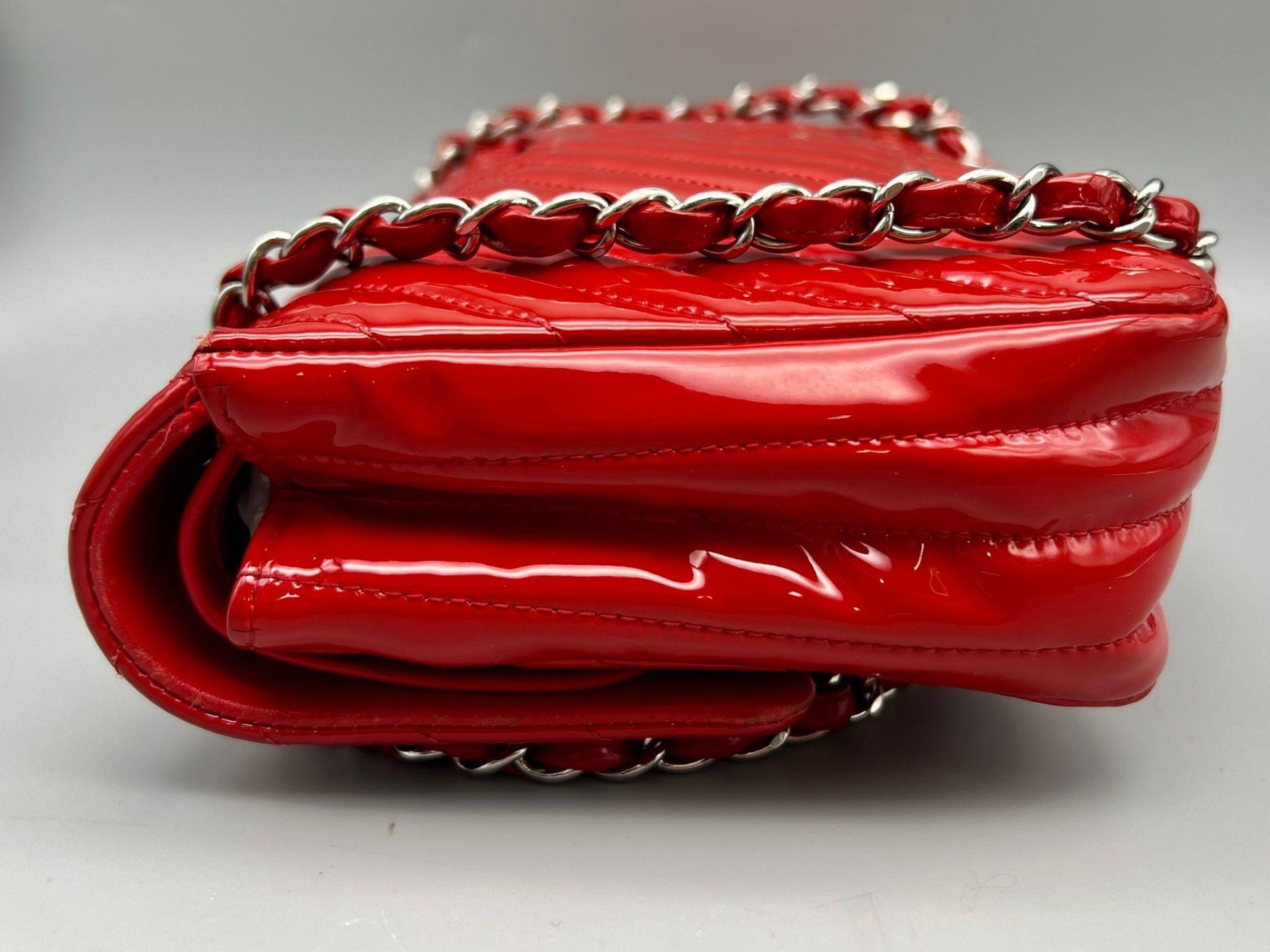 A Chanel Patent Leather Flap Handbag. Bright red patent leather quilted exterior. Classic Chanel - Image 2 of 7