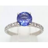 PLATINUM DIAMOND & TANZANITE RING, WITH A 1.40CT ROUND TANZANITE CENTRE AND DIAMOND SET SHOULDERS.