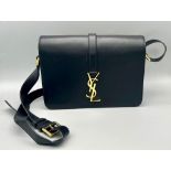 A Yves Saint Laurent (YSL) Black Leather Shoulder/Cross-body Bag. Adjustable shoulder strap. Gold-
