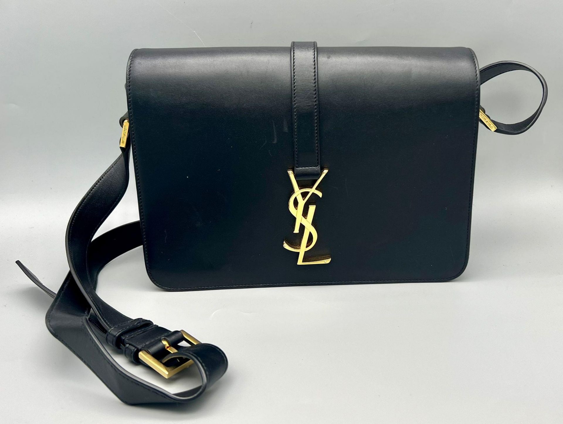 A Yves Saint Laurent (YSL) Black Leather Shoulder/Cross-body Bag. Adjustable shoulder strap. Gold-