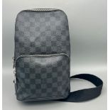 A Louis Vuitton Checked Canvas Messenger Bag. Silver-tone hardware. Zipped outer compartment.