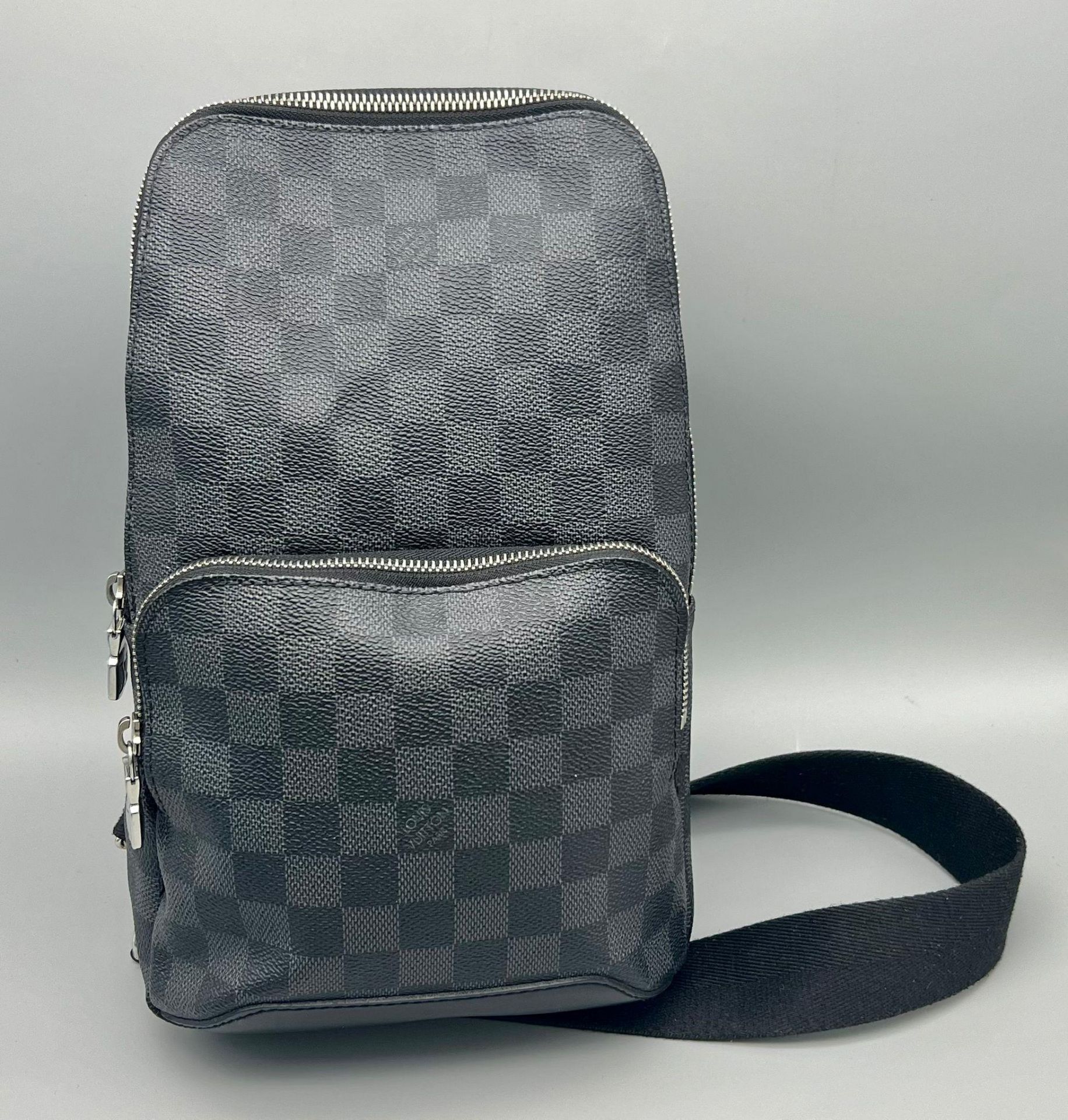 A Louis Vuitton Checked Canvas Messenger Bag. Silver-tone hardware. Zipped outer compartment.