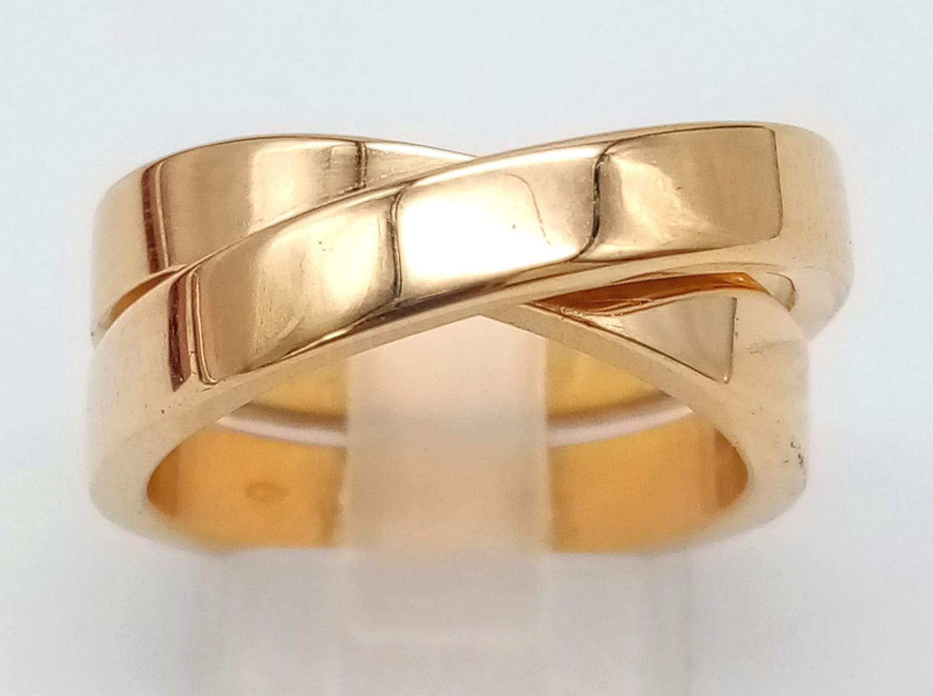CARTIER 18K YELLOW GOLD CROSS OVER RING WITH ORIGINAL PAPERWORK, WEIGHT 15.1G SIZE O