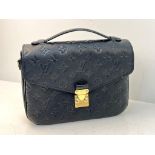 A Louis Vuitton Pochette Metis Leather Bag. Black monogram empreinte leather. Zipped exterior