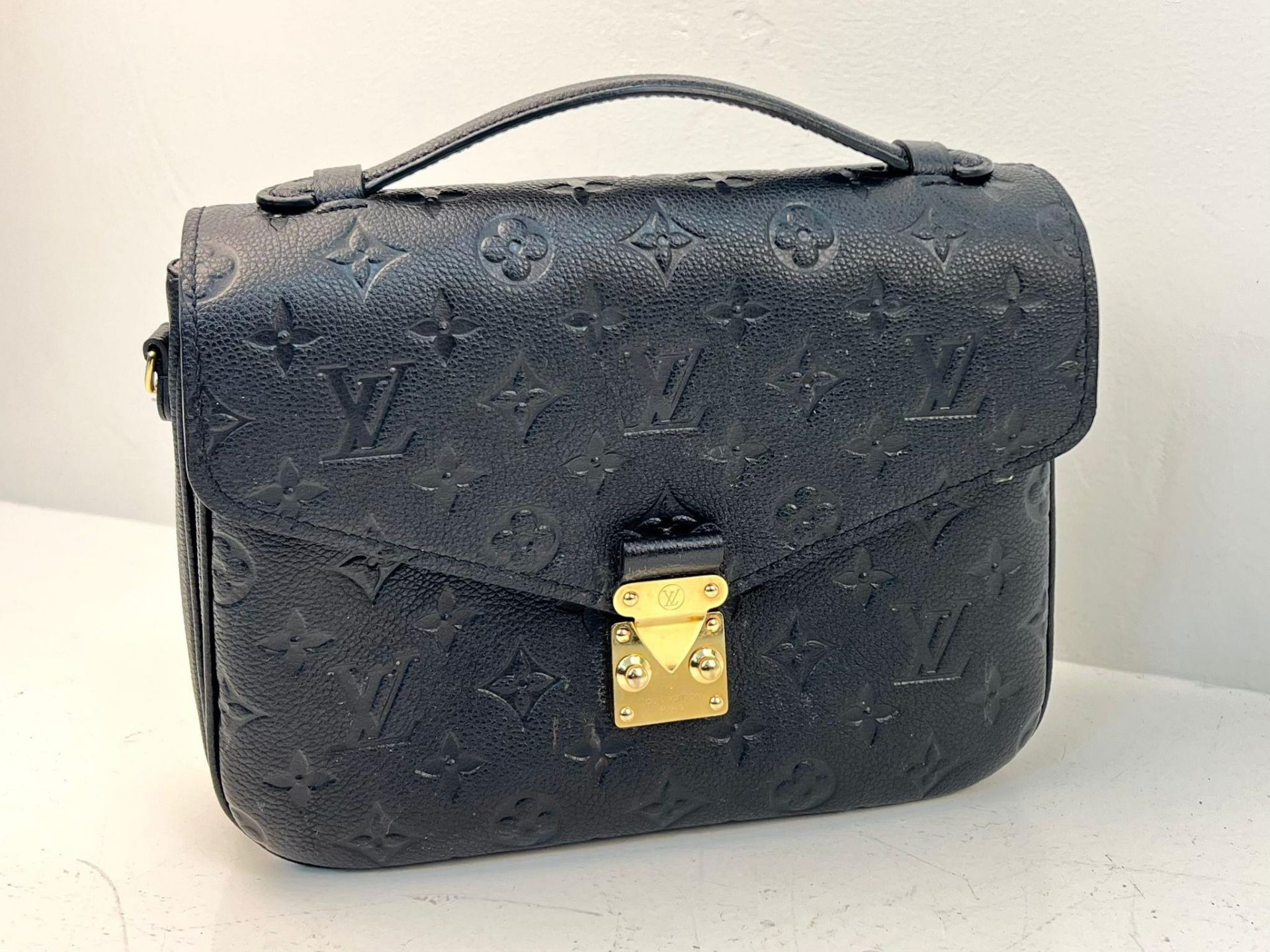 A Louis Vuitton Pochette Metis Leather Bag. Black monogram empreinte leather. Zipped exterior