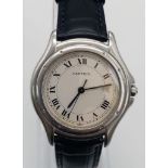 A Vintage Cartier Quartz Ladies Watch. Blue leather strap. Stainless steel case - 33mm. Cream dial