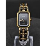 A SUPERBLY DESIGNED "CHANEL" FASION WATCH WITH BLACK DIAL AND LEATHER AND GOLD PLATED STRAP, COMES