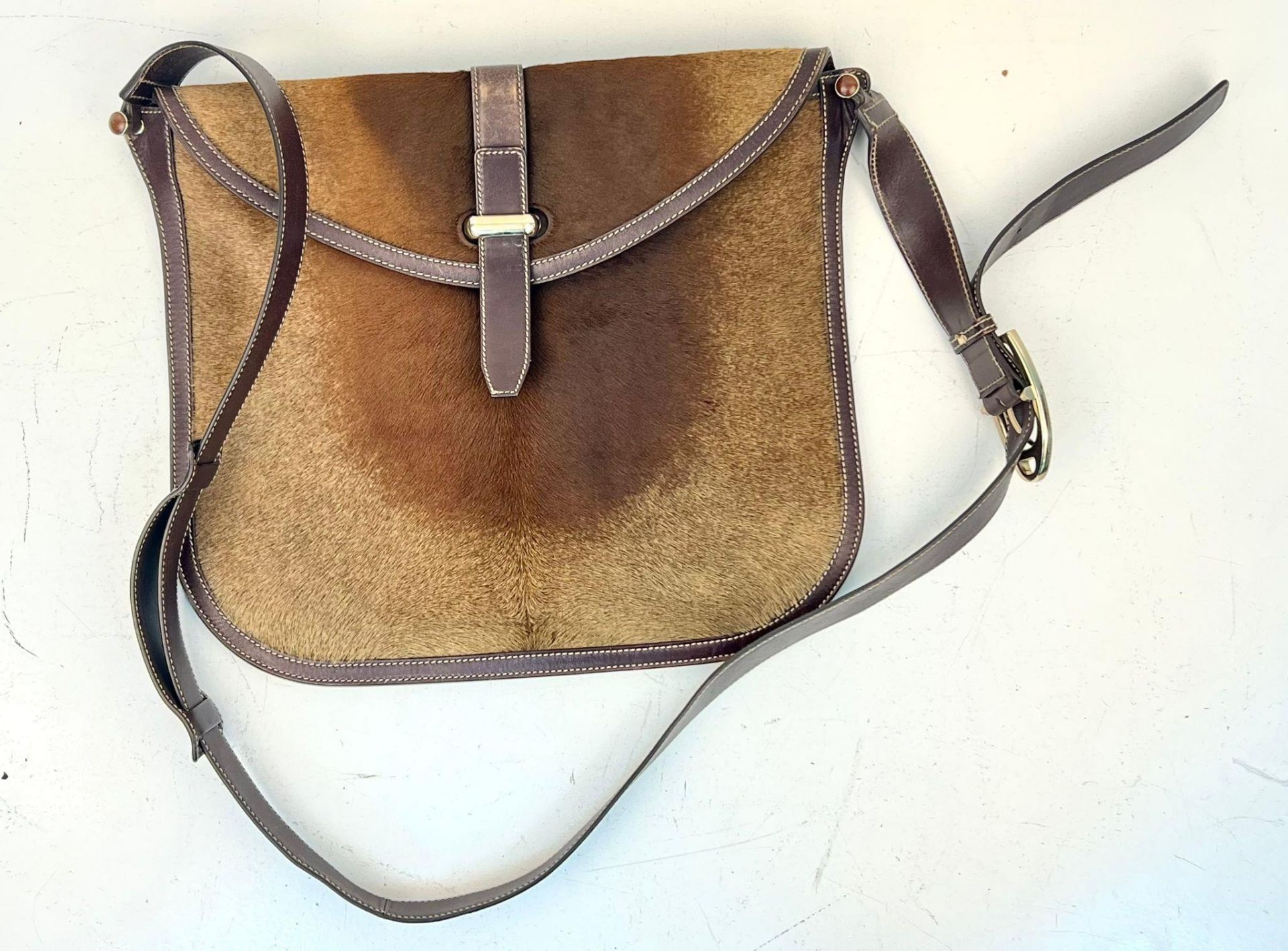 A Gucci Leather and Pony Hair Large Shoulder/Cross-body Bag. Adjustable strap. Gold-tone hardware.