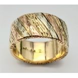 A 9K Tri-Colour Gold Band Ring. Diagonal waves of yellow, white and rose gold. Size Q. 10.21g