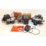 A Selection of Four Vintage Cameras and a Light Meter.
