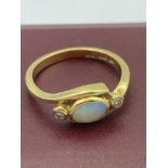 Beautiful 18 carat GOLD and OPAL RING, having centre Opal gemstone to top with DIAMOND to either