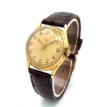 A Vintage Ebel 18K Gold Cased Watch. Brown leather strap. 18K gold case - 32mm. Gold tone dial.