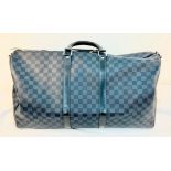 A Louis Vuitton Large Keepall Luggage Bag. Black and blue checked canvas. Leather trim and