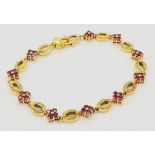 18K YELLOW GOLD RUBY SET BRACELET. TOTAL WEIGHT 11.26G