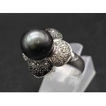 An 18K White Gold, Diamond and Tahitian South Sea Pearl Ring. Large, beautiful central pearl (