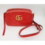 A Gucci Marmont Red Leather Monogram Shoulder Bag. Adjustable shoulder strap. Gilded hardware.