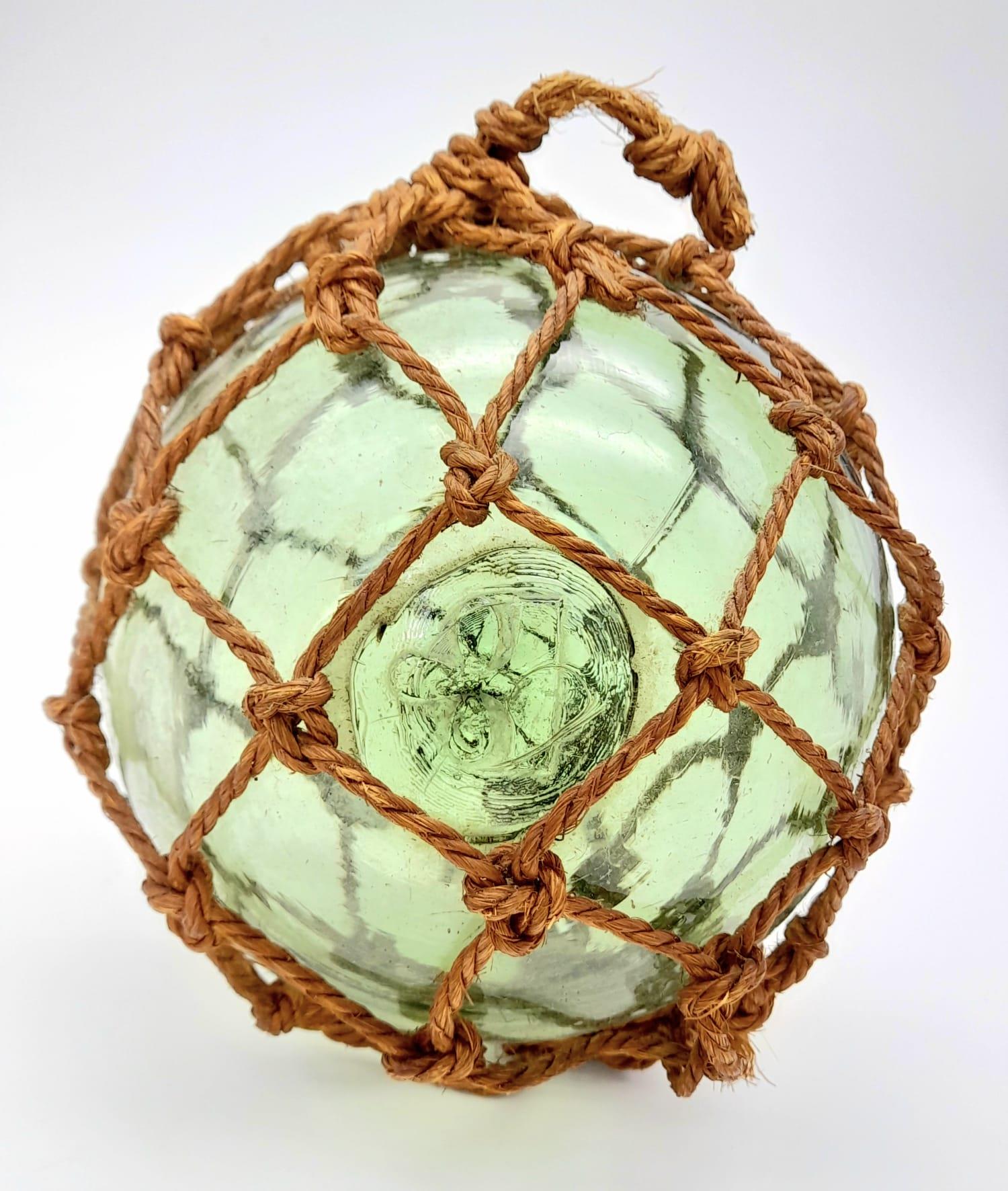 An Antique Japanese Glass Fishing Float with a Lovely Pontil Mark and Netting.