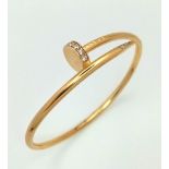 18K YELLOW GOLD CARTIER STYLE STONE SET NAIL BANGLE. TOTAL WEIGHT 10.5G