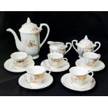 AN INTERESTING JAPANESE BONE CHINA TEA SET WITH GOLD PATTERN AND GEISHA IMAGES IN THE BOTTOM OF