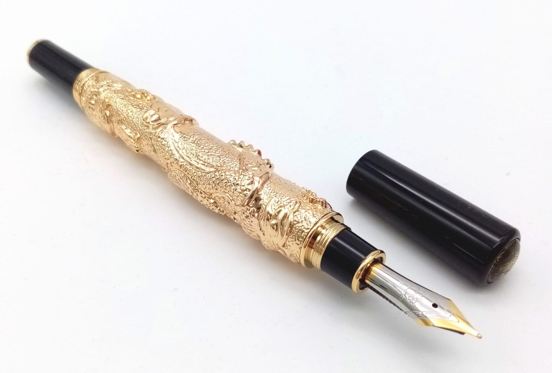 A very satisfactory to handle, heavy (70.8 g.) fountain pen with a Chinese Dragon featuring red
