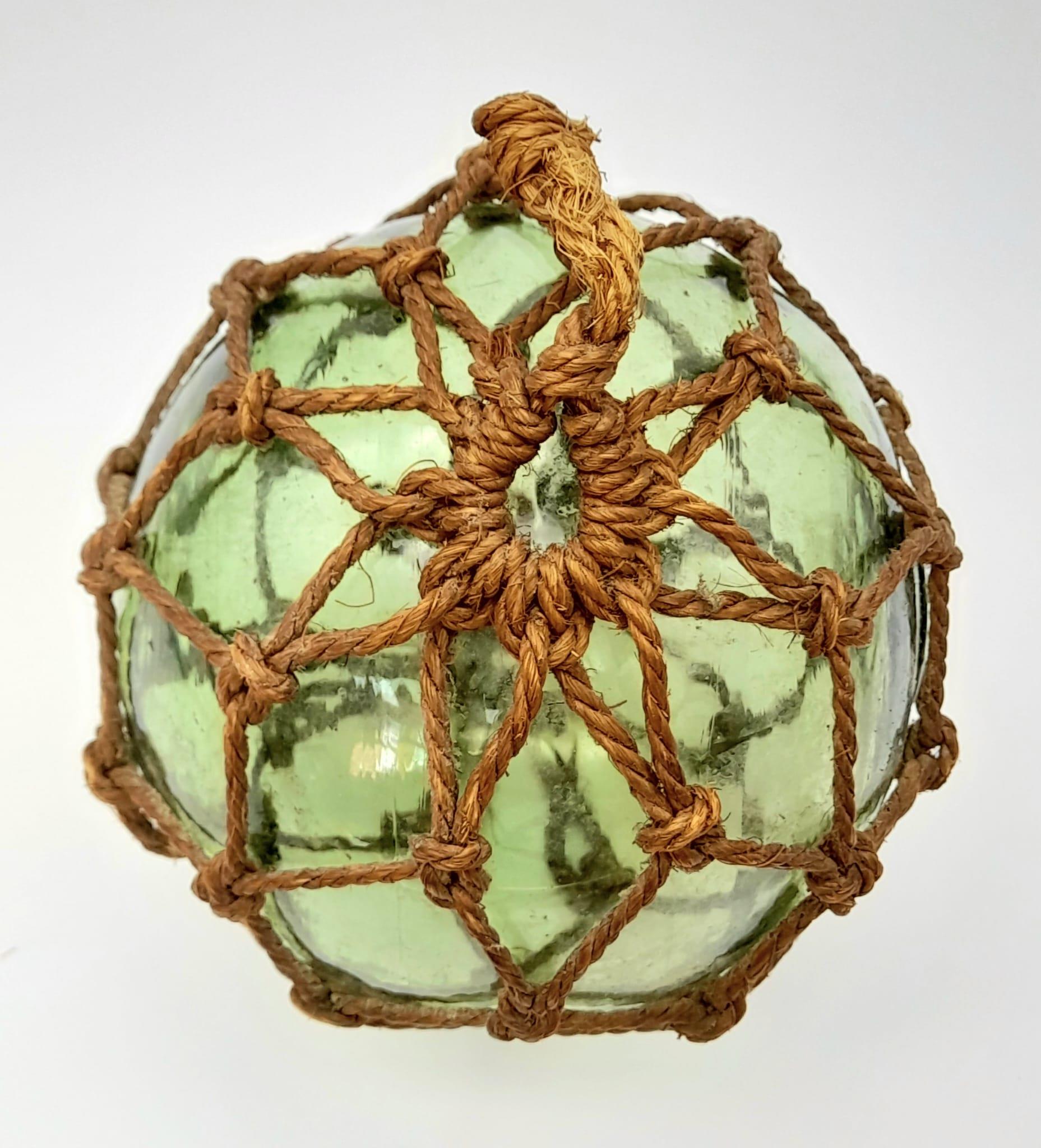 An Antique Japanese Glass Fishing Float with a Lovely Pontil Mark and Netting. - Image 3 of 4