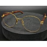 A PAIR OF CARTIER GLASSES WITH THE DISTINCTIVE DESIGNER LOOK IN ORIGINAL CARTIER BOX . REF 13034