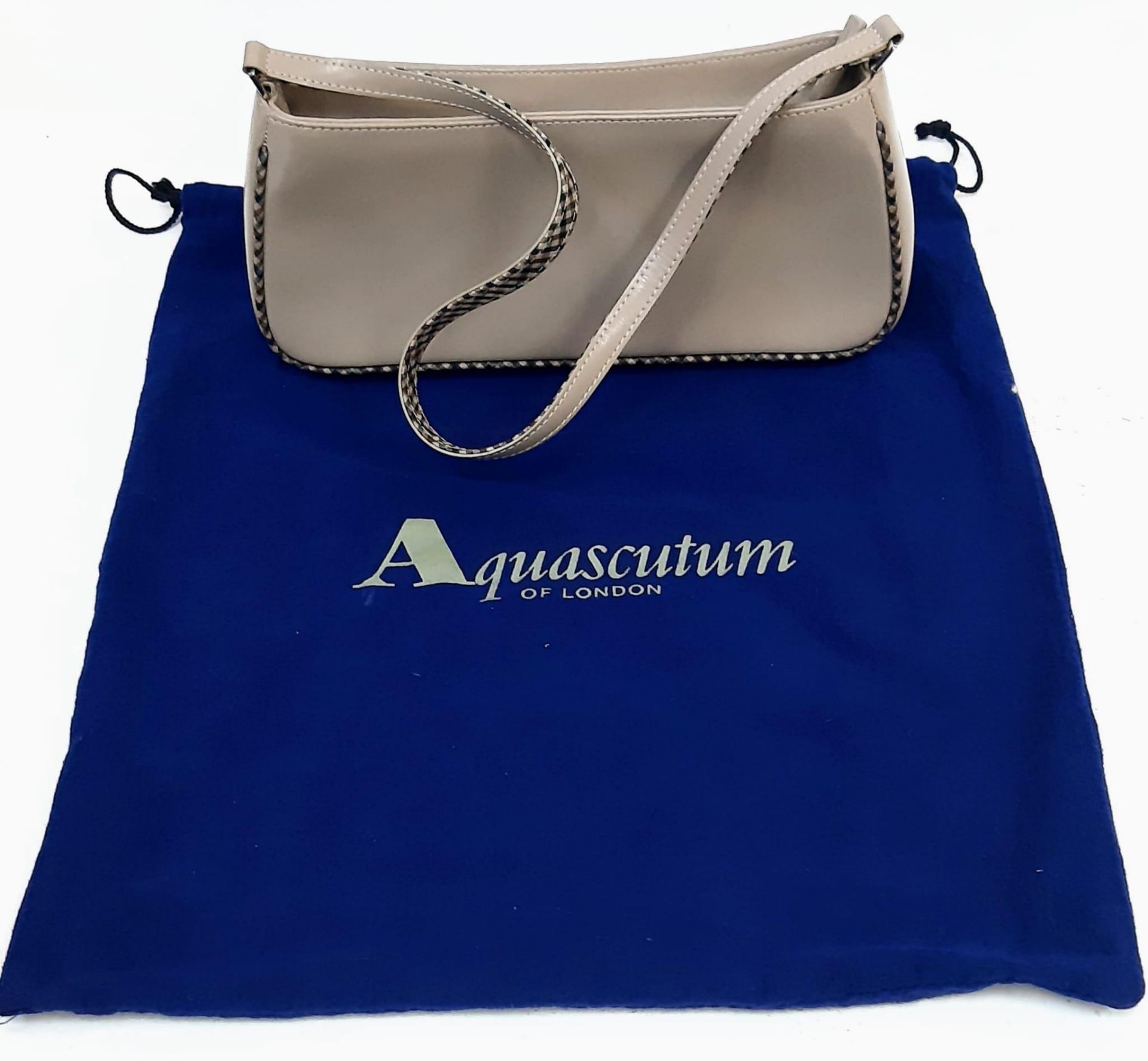 An Aquascutum Beige Leather Baguette Handbag with Dust-Cover. In good condition but pleases see