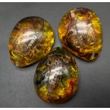 Not one but three scorpions preserved in amber resin! May be used as pendants or paperweights or