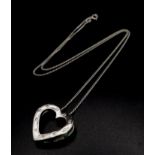 A modern, 9 K white gold heart shaped pendant with diamonds and a chain 41 cm long. Total weight: