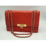 A Beautiful Classic Chanel Jumbo Flap Bag. Red quilted caviar leather with gold-tone Chanel logo-