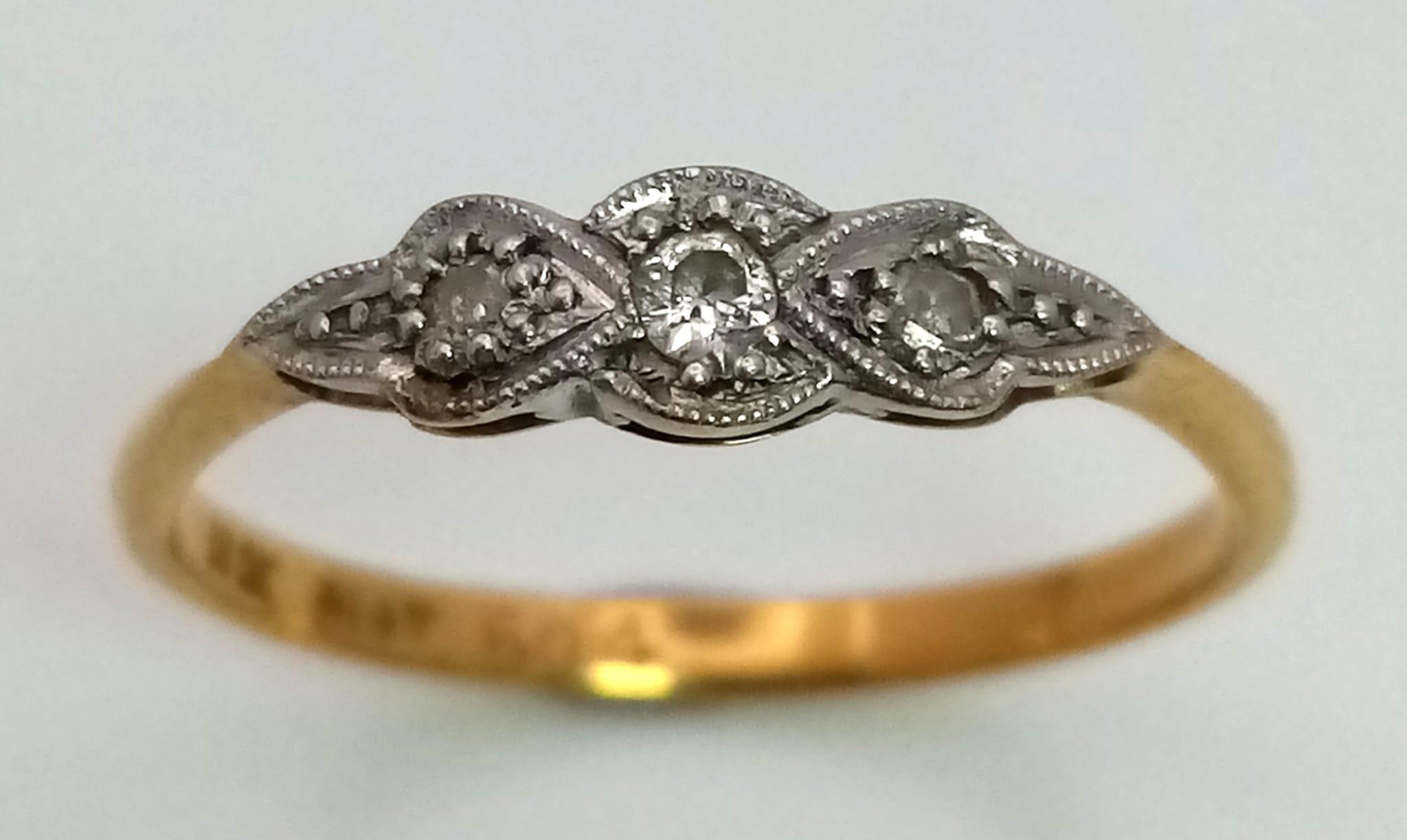 An 18 K yellow gold and platinum ring with a trilogy of diamonds. Ring size: N, weight: 1.7 g. - Image 2 of 7