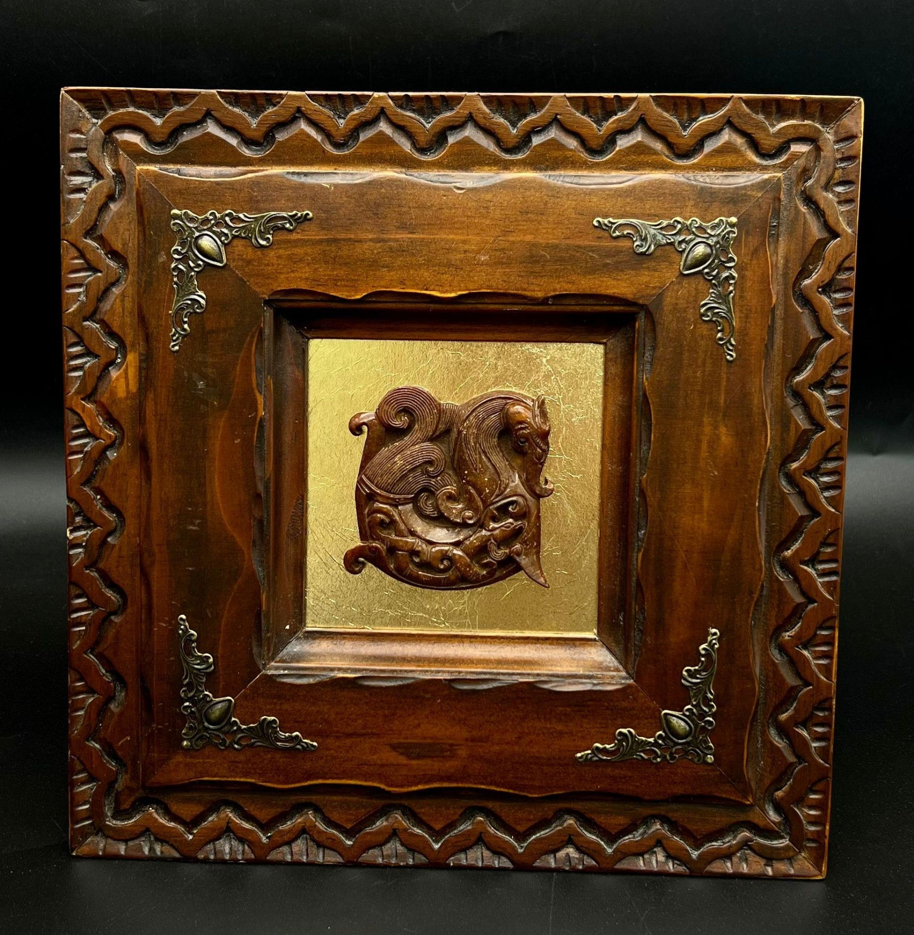 An antique, Chinese, hand carved brown jade amulet with mythical beasts (6 X 6 cm), presented in a