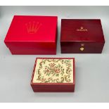 TWO spectacular ROLEX watch cases. One is made from high gloss cherry veneer and polished with a