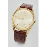 A VINTAGE 9K GOLD GENTS OMEGA WATCH ON THE ORIGINAL BROWN OMEGA STRAP , G.W.O. 34mm 013125