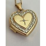 9 carat GOLD LOCKET with DIAMOND detail mounted on a fine 9 carat GOLD CHAIN. 1.5 grams.45 cm.